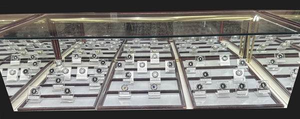 Loose lab-grown diamonds displayed in a showroom case at Elite Fine Jewelers