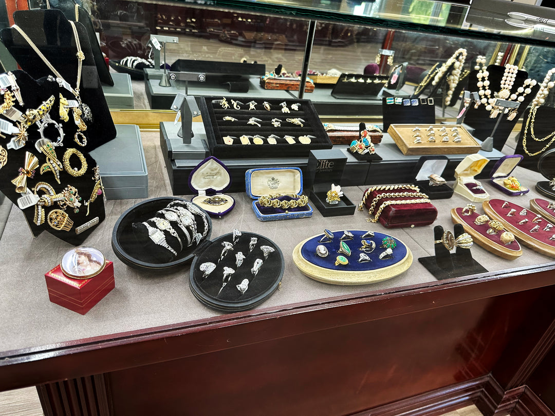 Vintage jewelry showcase with fine jewelry ranging from solid gold bracelets to vintage diamond watches to brooches and engagement rings at Elite Fine Jewelers