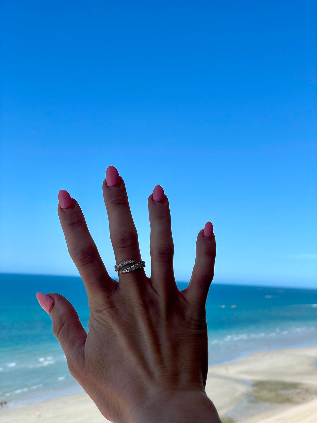 14k Diamond Bypass Wrap Ring in White gold - Elite Fine Jewelers ring with a beach background